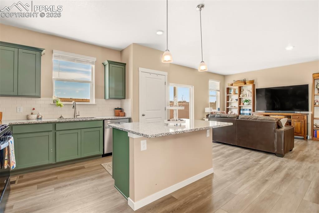 6133 Alpine Ridge Drive Colorado Springs, CO 80925 - Photo 7 of 31 a living room with furniture and a flat screen tv