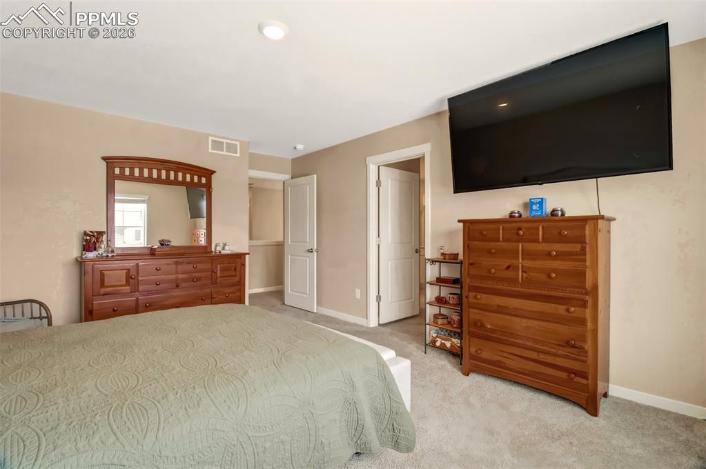 6133 Alpine Ridge Drive Colorado Springs, CO 80925 - Photo 10 of 31 a room with a bed and television