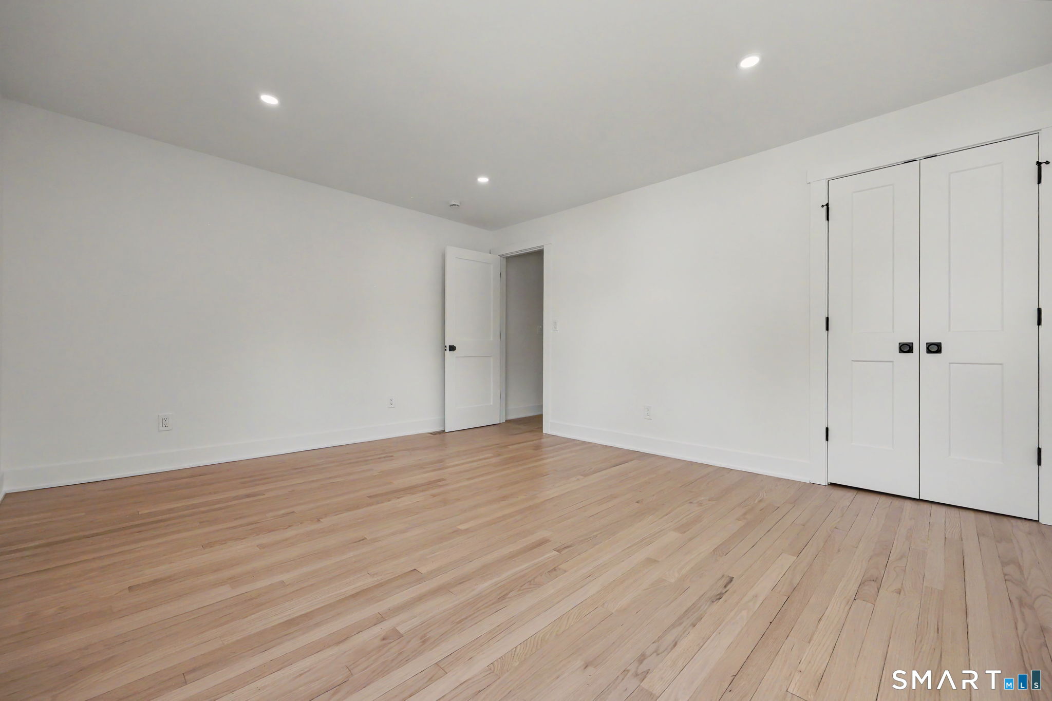 91 Lockwood Road Fairfield, CT 06825 - Photo 22 of 38 a view of an empty room with wooden floor