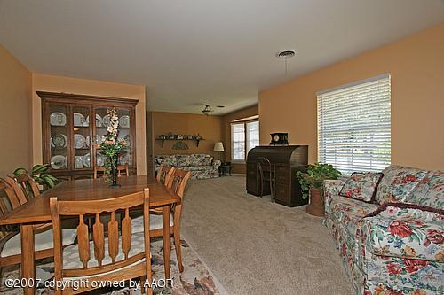 7103 Calumet Road Amarillo, TX 79106 - Photo 3 of 14 a dining room with furniture and wooden floor