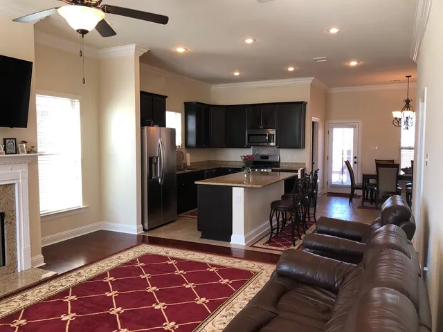 a kitchen with stainless steel appliances granite countertop a refrigerator and a stove top oven