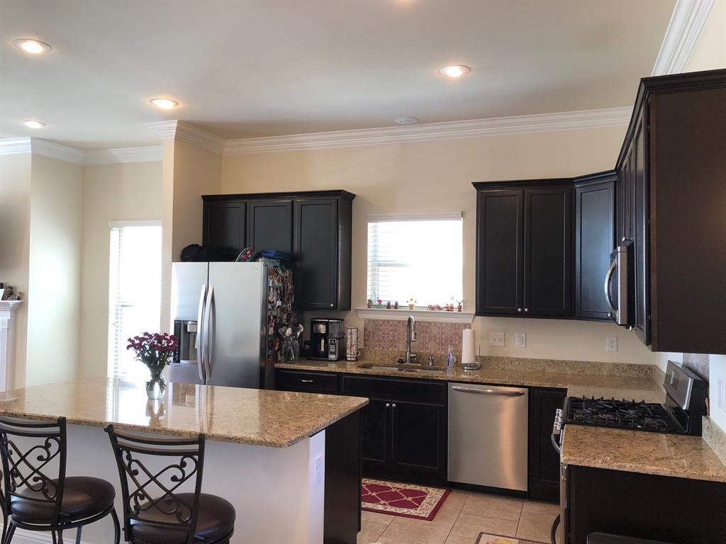 218 Apalachee Way Bossier City, LA 71111 - Photo 3 of 7 a kitchen with stainless steel appliances granite countertop a refrigerator and a stove top oven