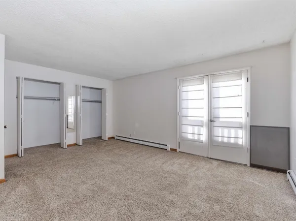 an empty room with closet area