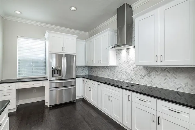 a kitchen with white cabinets and sink
