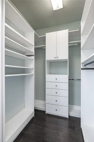 a view of walk in closet with empty racks