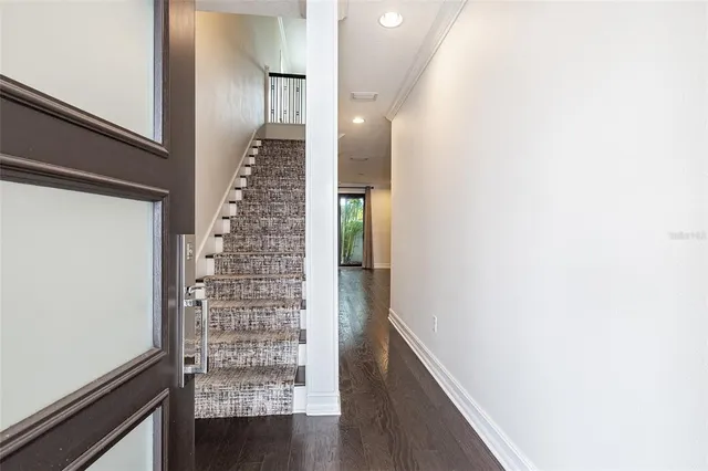 a view of an empty room with wooden floor