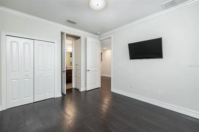 a view of kitchen with wooden floor and electronic appliances