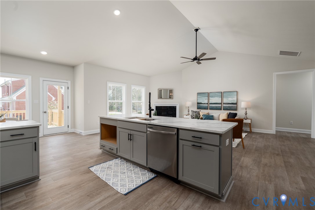 2301 Larkwood Road Henrico, VA 23294 - Photo 21 of 44 a kitchen with kitchen island granite countertop a sink cabinets and wooden floor