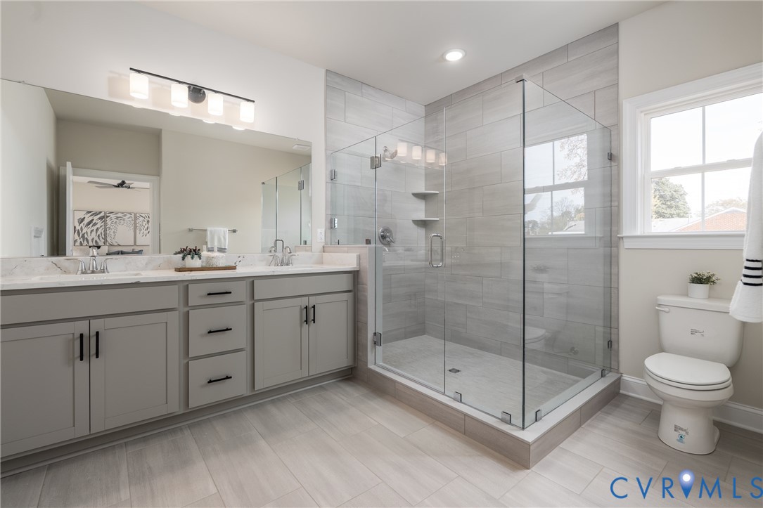 2301 Larkwood Road Henrico, VA 23294 - Photo 27 of 44 a spacious bathroom with a shower sink vanity mirror and toilet