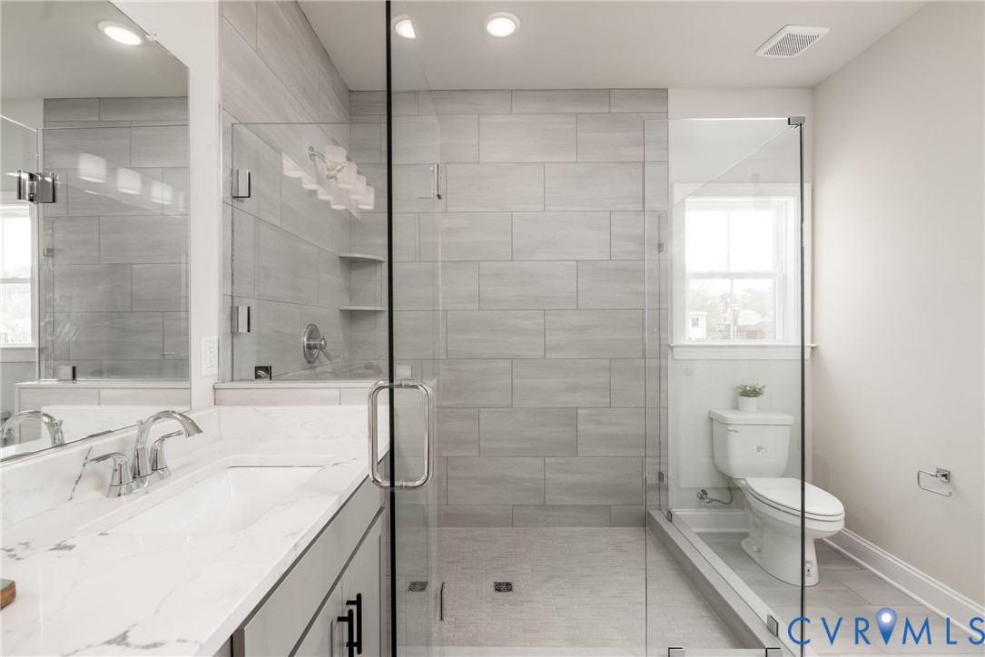 2301 Larkwood Road Henrico, VA 23294 - Photo 28 of 44 a bathroom with a shower sink and mirror