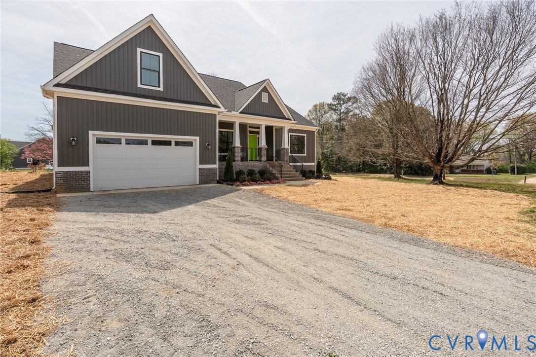 2301 Larkwood Road Henrico, VA 23294 - Photo 3 of 44 a front view of a house with a yard and garage