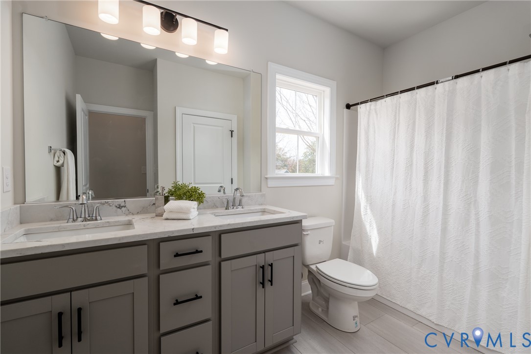 2301 Larkwood Road Henrico, VA 23294 - Photo 32 of 44 a bathroom with a toilet a sink and a mirror