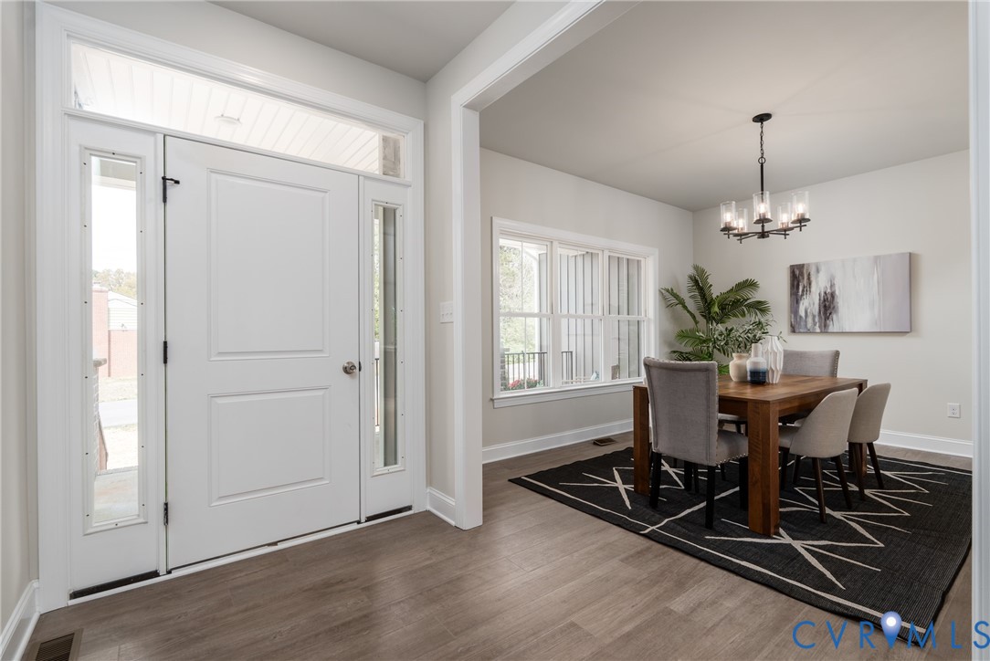 2301 Larkwood Road Henrico, VA 23294 - Photo 6 of 44 a view of a dining room with furniture window and wooden floor