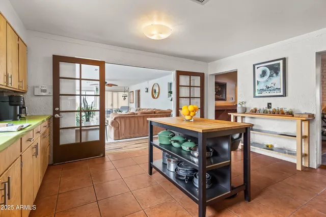 a living room with furniture and a kitchen view