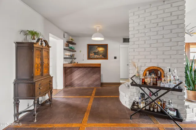 a living room with furniture a rug and a fireplace