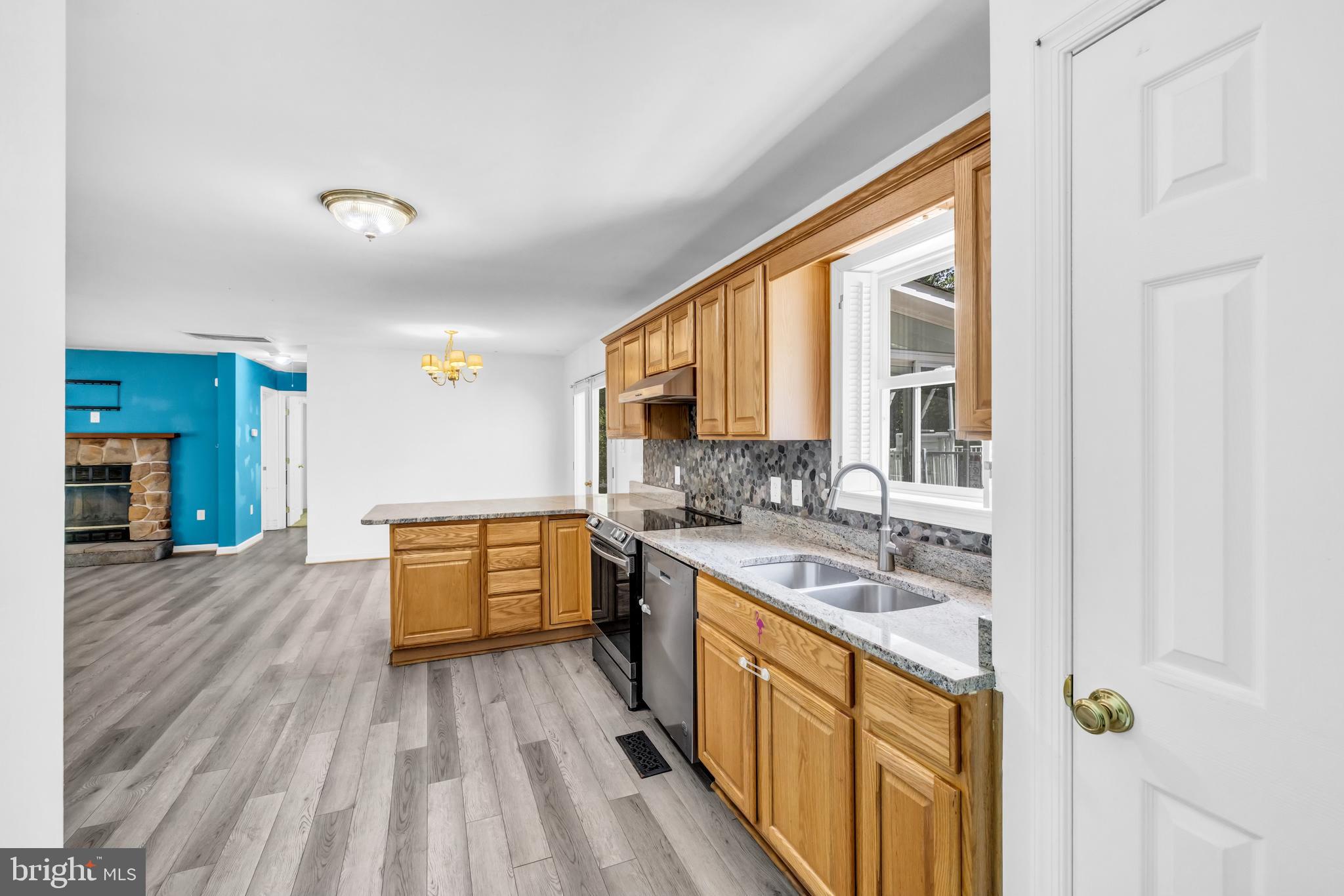 7392 Todds Wharf Road Preston, MD 21655 - Photo 15 of 63 a large kitchen with a lot of counter space and wooden floor