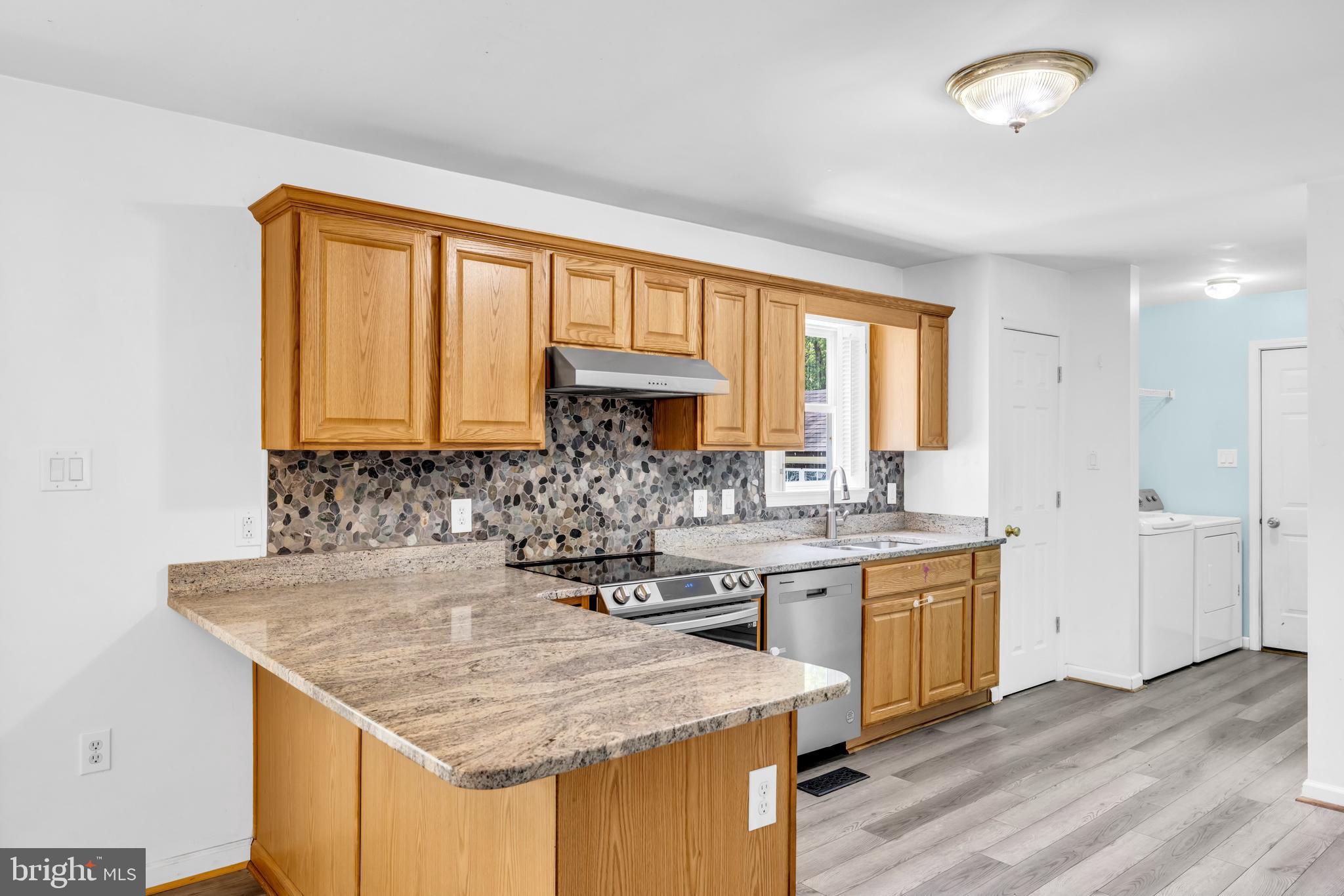 7392 Todds Wharf Road Preston, MD 21655 - Photo 18 of 63 a kitchen with a sink stove and cabinets