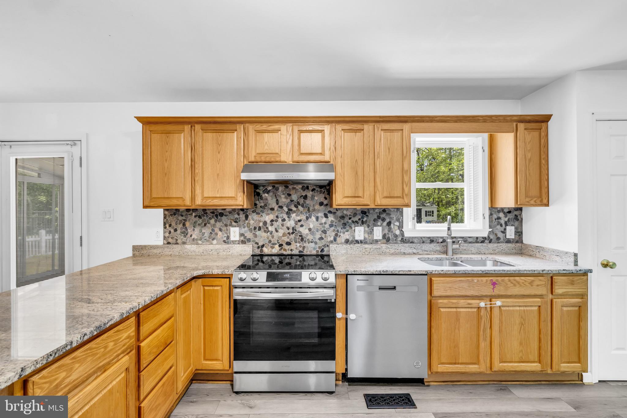7392 Todds Wharf Road Preston, MD 21655 - Photo 19 of 63 a kitchen with stainless steel appliances granite countertop a stove and a sink