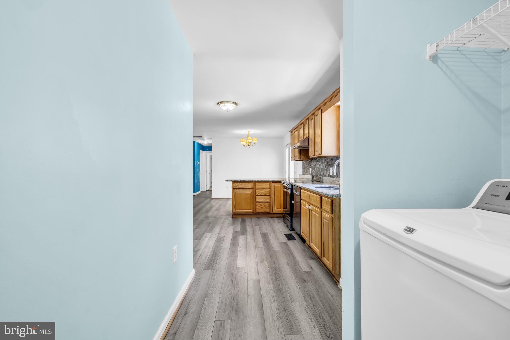 7392 Todds Wharf Road Preston, MD 21655 - Photo 23 of 63 a view of washer and dryer with wooden floor