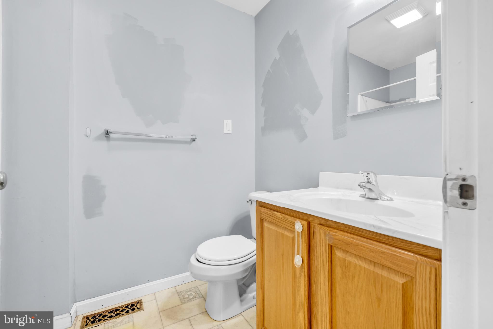 7392 Todds Wharf Road Preston, MD 21655 - Photo 27 of 63 a bathroom with a granite countertop sink toilet and a mirror