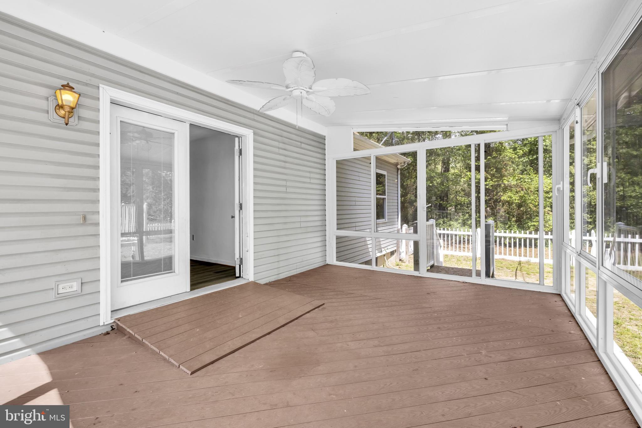 7392 Todds Wharf Road Preston, MD 21655 - Photo 30 of 63 a view of an empty room with wooden floor and windows