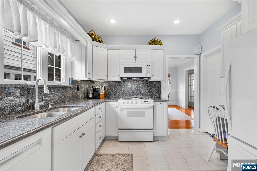 106 Maple Street Rutherford, NJ 07070 - Photo 23 of 50 a kitchen with stainless steel appliances a stove a sink and a refrigerator