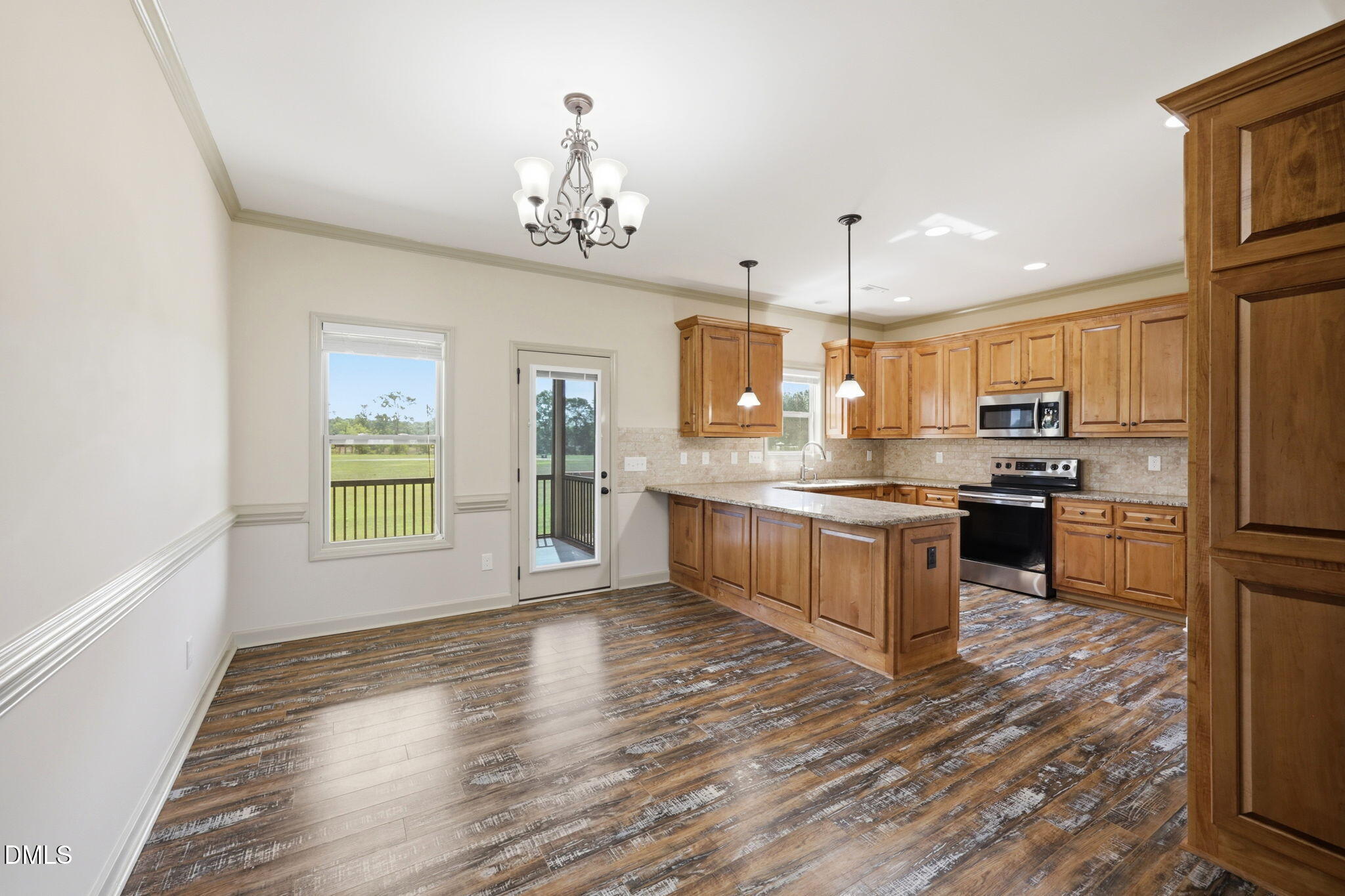 3587 Hannah Creek Road Benson, NC 27504 - Photo 8 of 43 a large kitchen with kitchen island a center island and stainless steel appliances