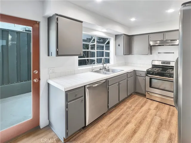 a kitchen with a sink stove and cabinets