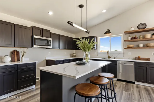 a kitchen with a stove a sink and a refrigerator