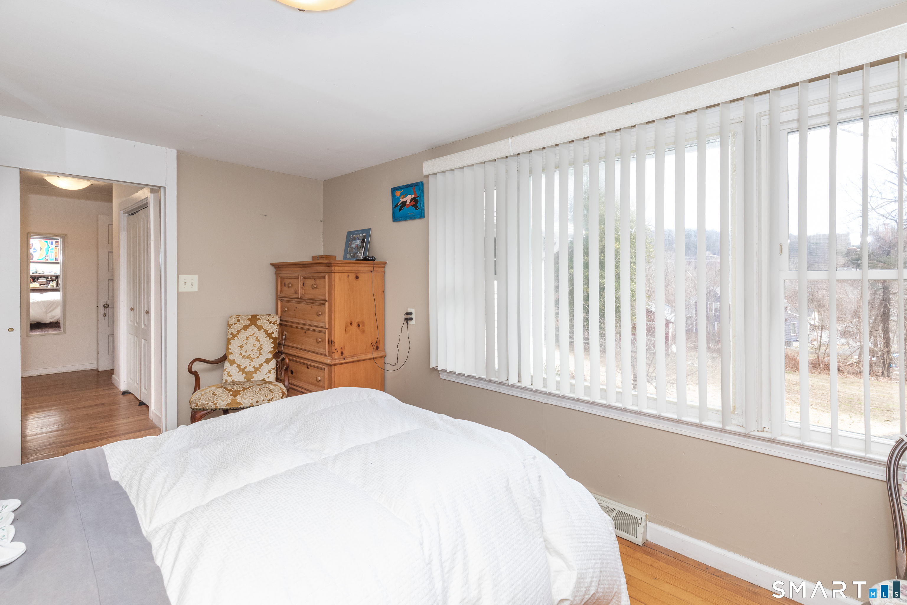 14 Laurel Trail Newtown, CT 06482 - Photo 22 of 39 a bedroom with a large bed and wooden floor