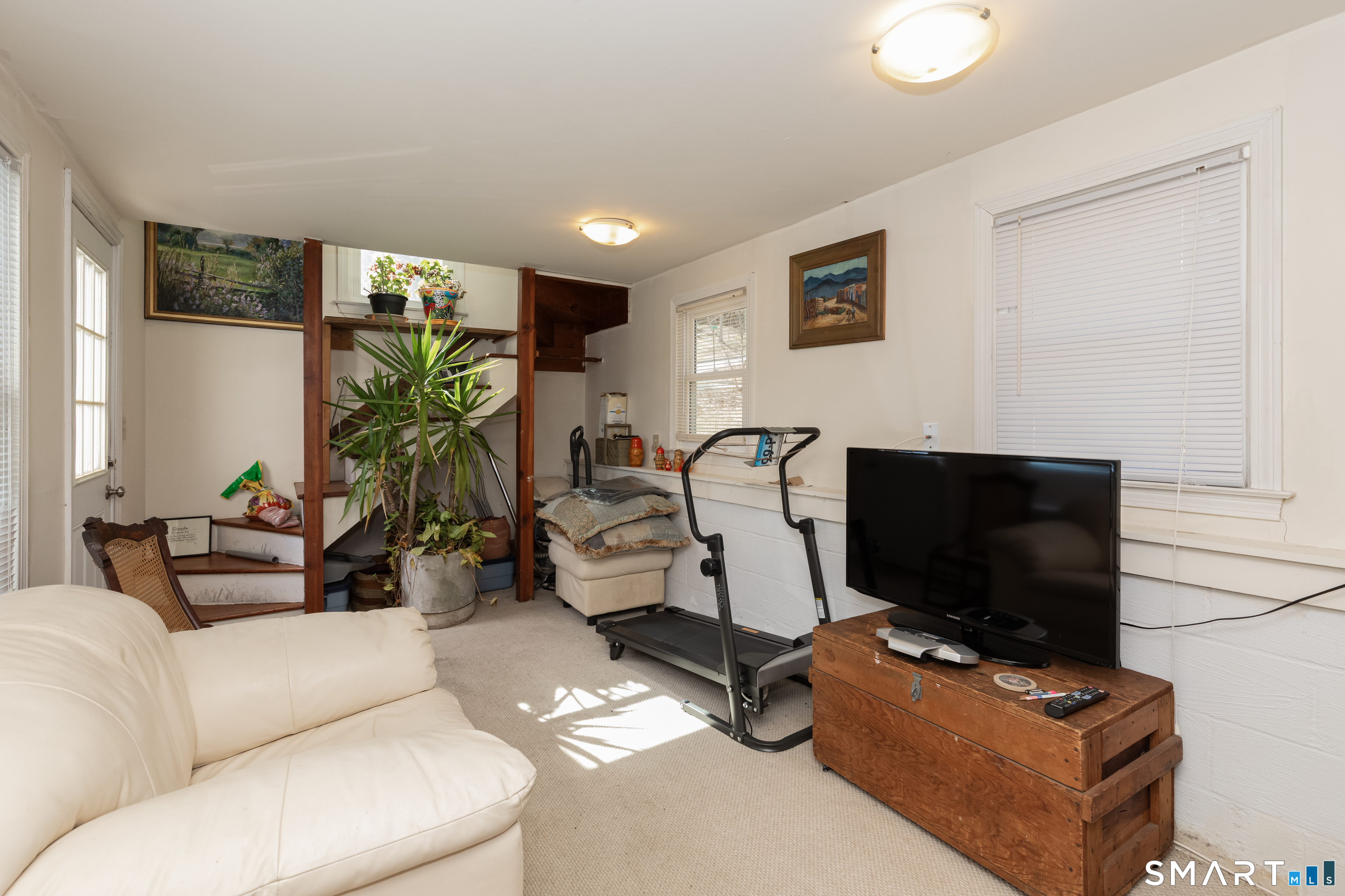 14 Laurel Trail Newtown, CT 06482 - Photo 27 of 39 a living room with furniture and a flat screen tv