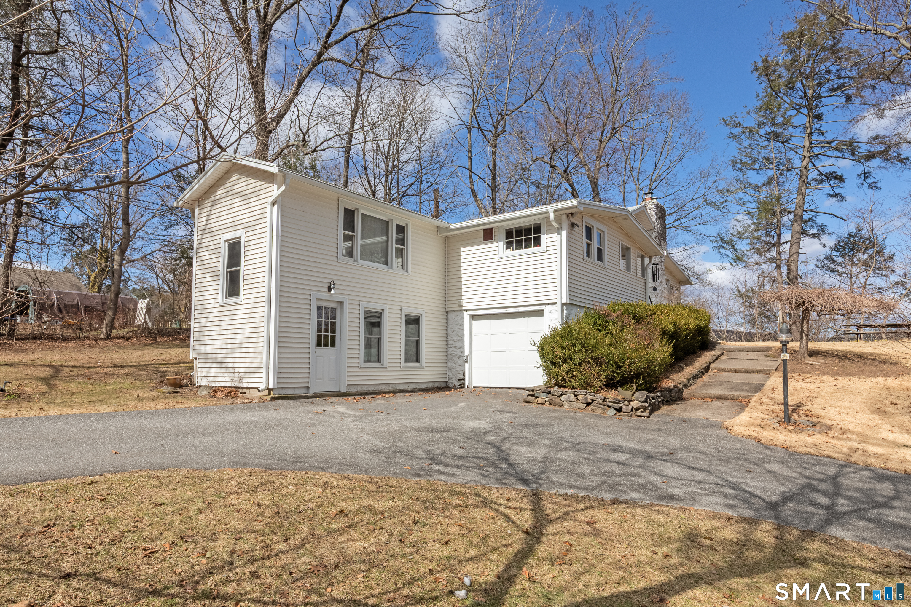 14 Laurel Trail Newtown, CT 06482 - Photo 5 of 39 a front view of a house with a yard
