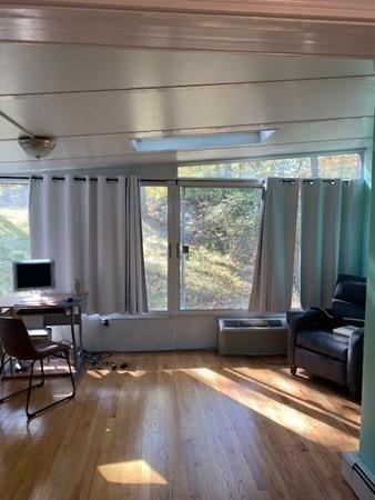 20 Walnut Road Boston, MA 02132 - Photo 19 of 34 a living room with a large window and furniture