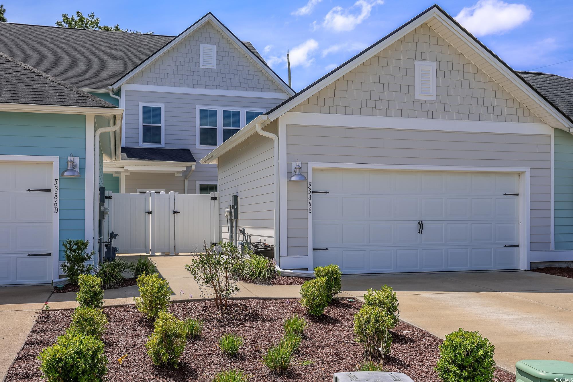 5386 Knobcone Loop, Unit E Myrtle Beach, SC 29577 - Photo 1 of 34 View of front of property with a gate, concrete driveway, and an attached garage