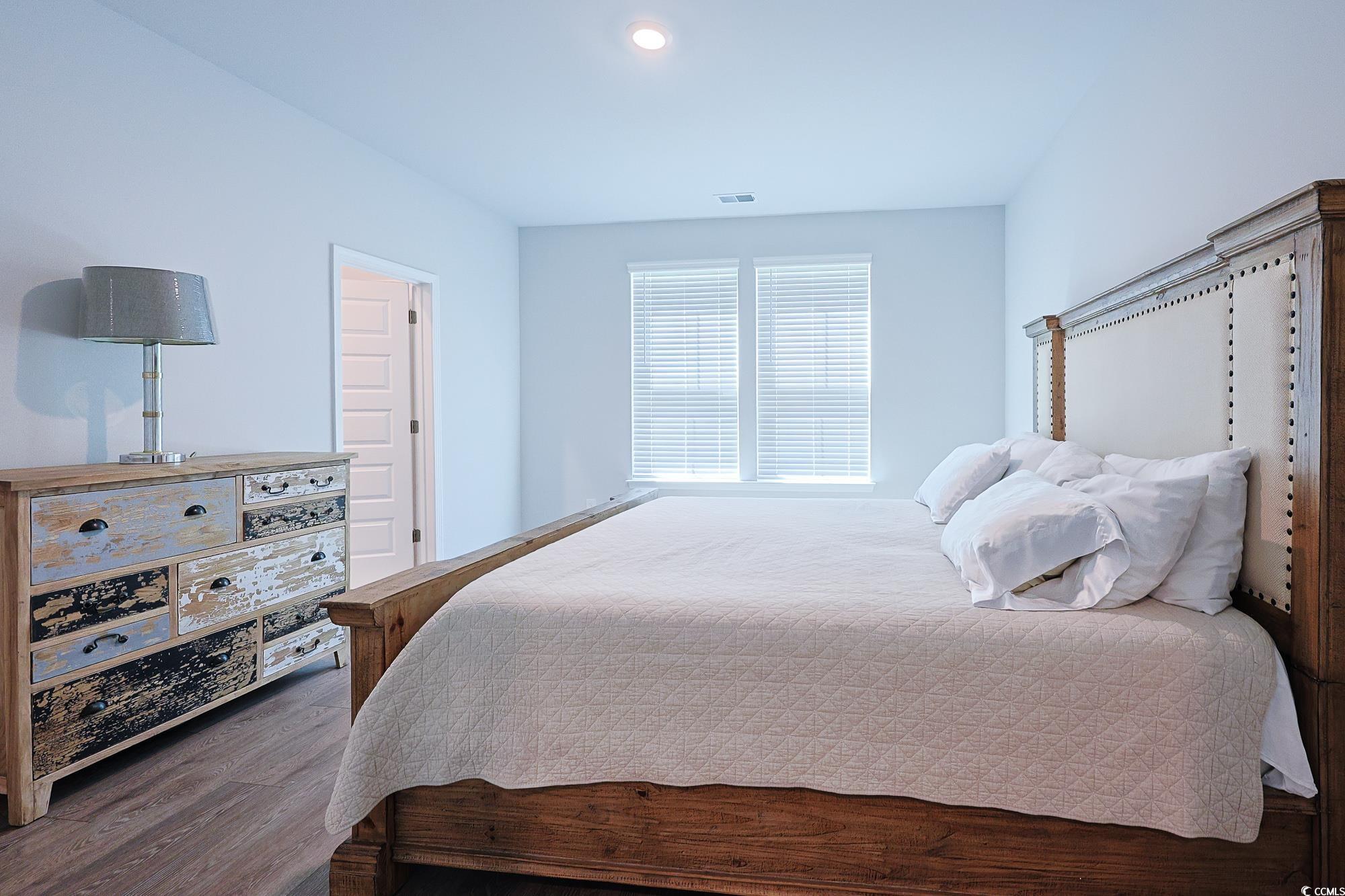 5386 Knobcone Loop, Unit E Myrtle Beach, SC 29577 - Photo 31 of 34 Bedroom with dark wood-style flooring and baseboards