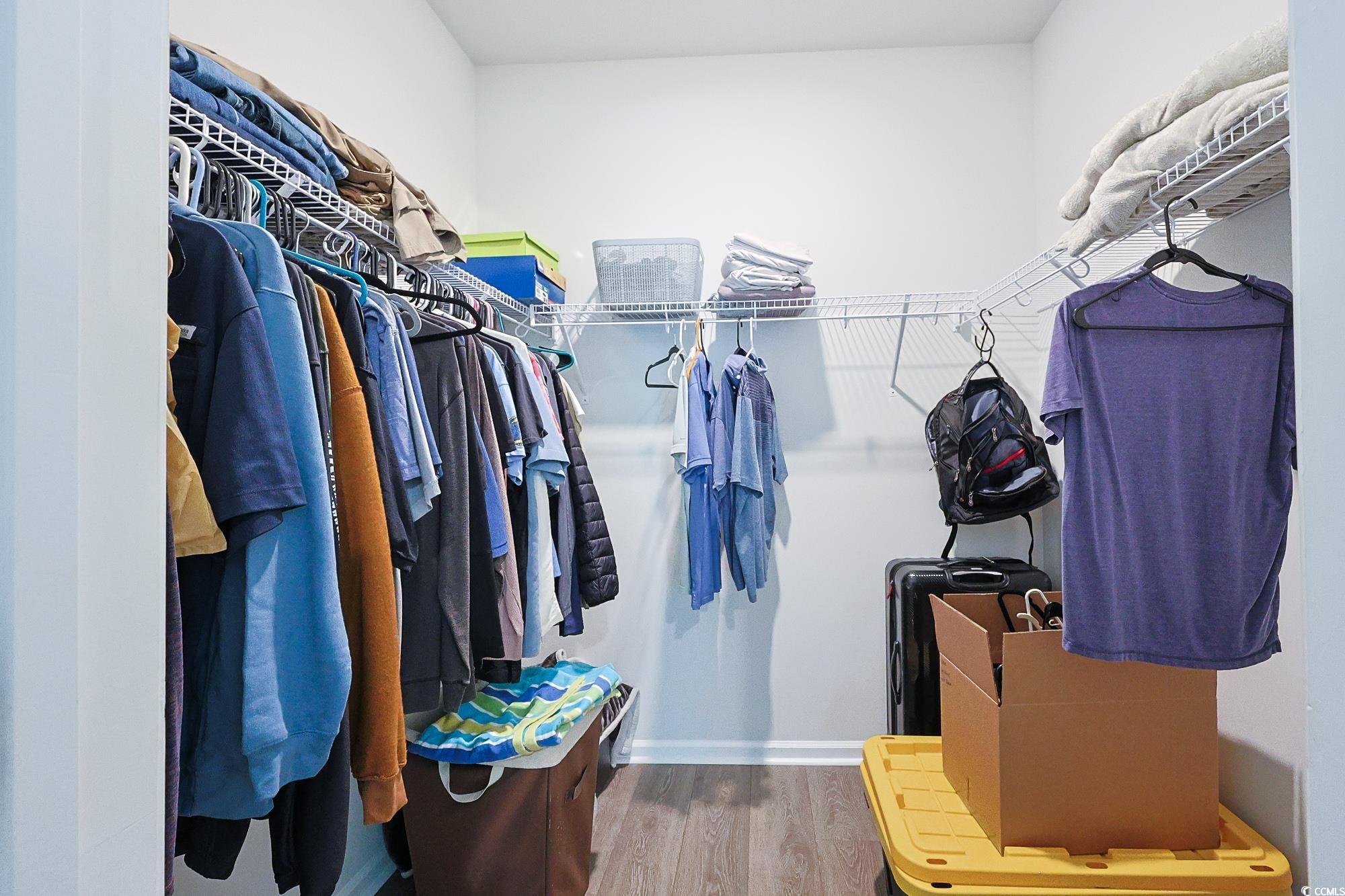 5386 Knobcone Loop, Unit E Myrtle Beach, SC 29577 - Photo 33 of 34 Bedroom with wood finished floors, a walk in closet, ensuite bathroom, and recessed lighting