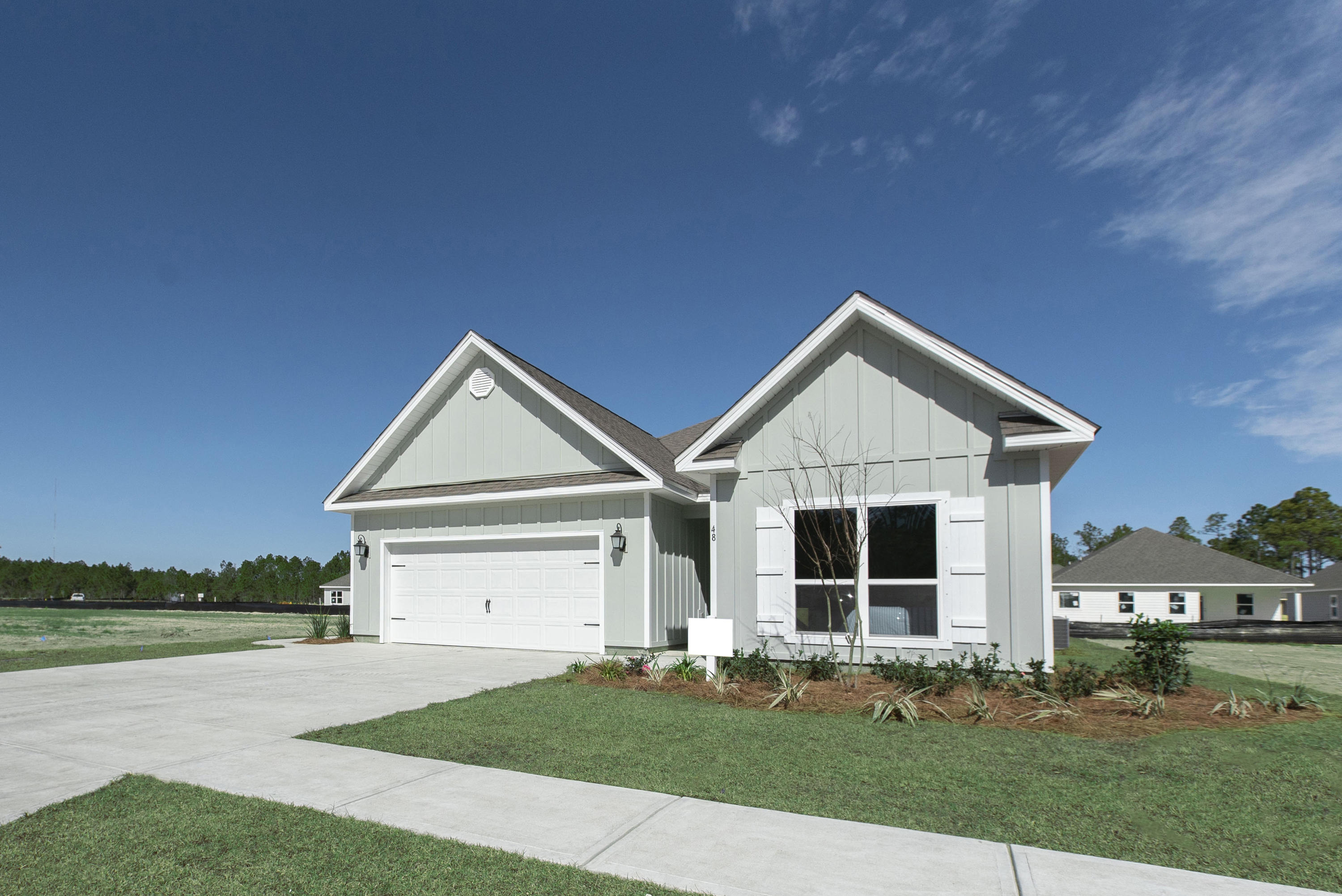 238 Stonegate Circle, Unit 33 Santa Rosa Beach, FL 32459 - Photo 1 of 26 a front view of a house with a yard and garage