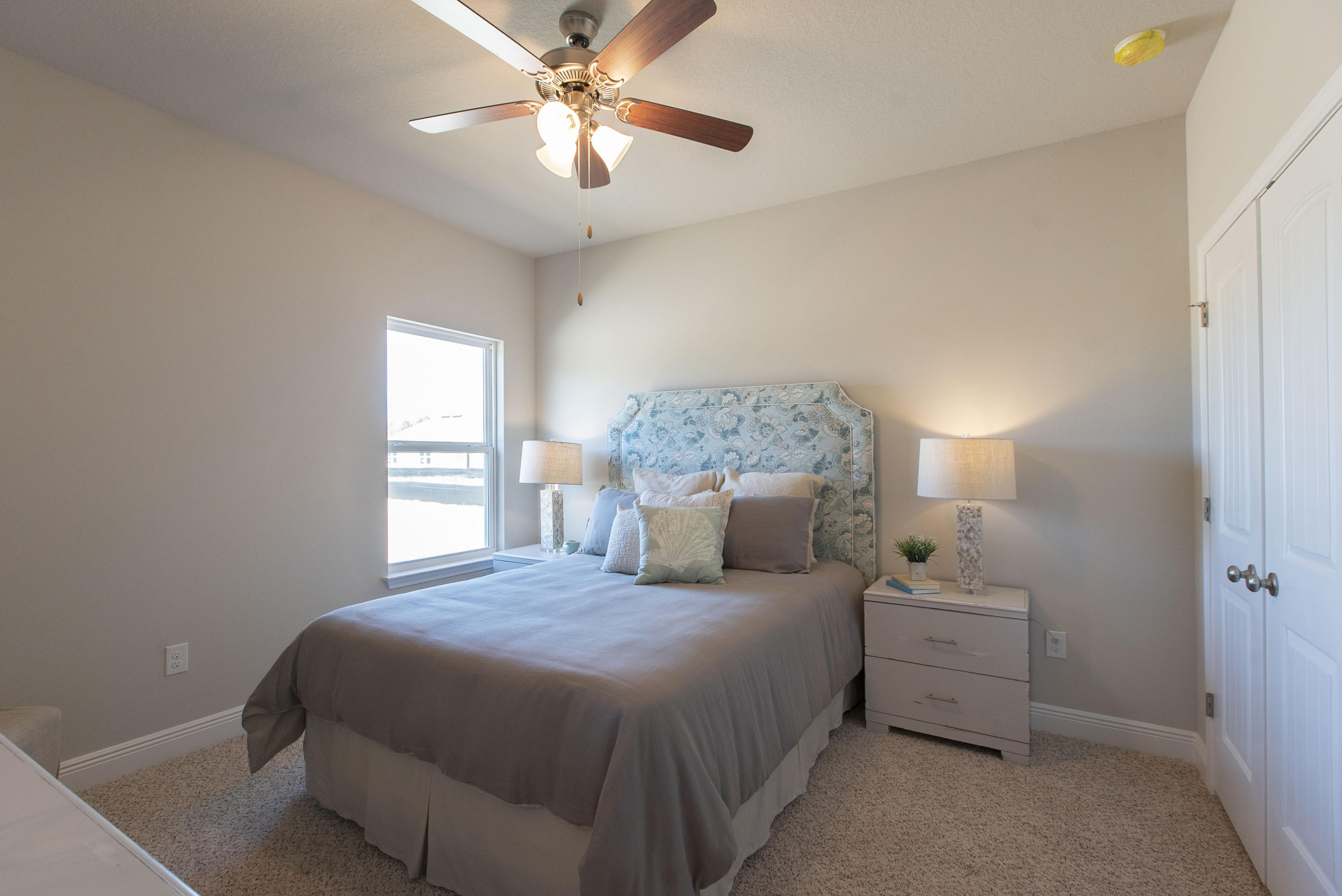 238 Stonegate Circle, Unit 33 Santa Rosa Beach, FL 32459 - Photo 8 of 26 a bedroom with a bed and a chandelier