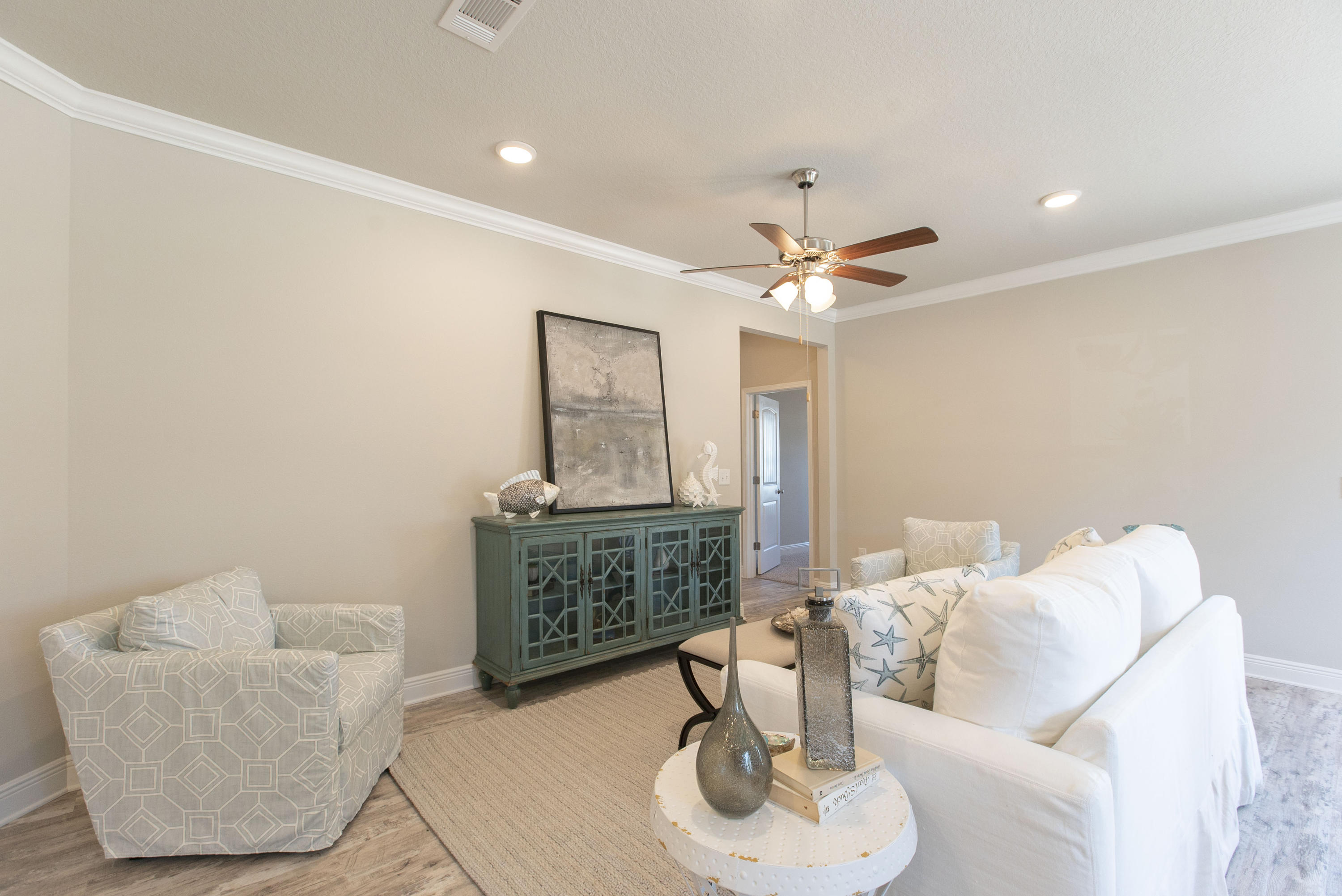 238 Stonegate Circle, Unit 33 Santa Rosa Beach, FL 32459 - Photo 9 of 26 a living room with furniture and a chandelier