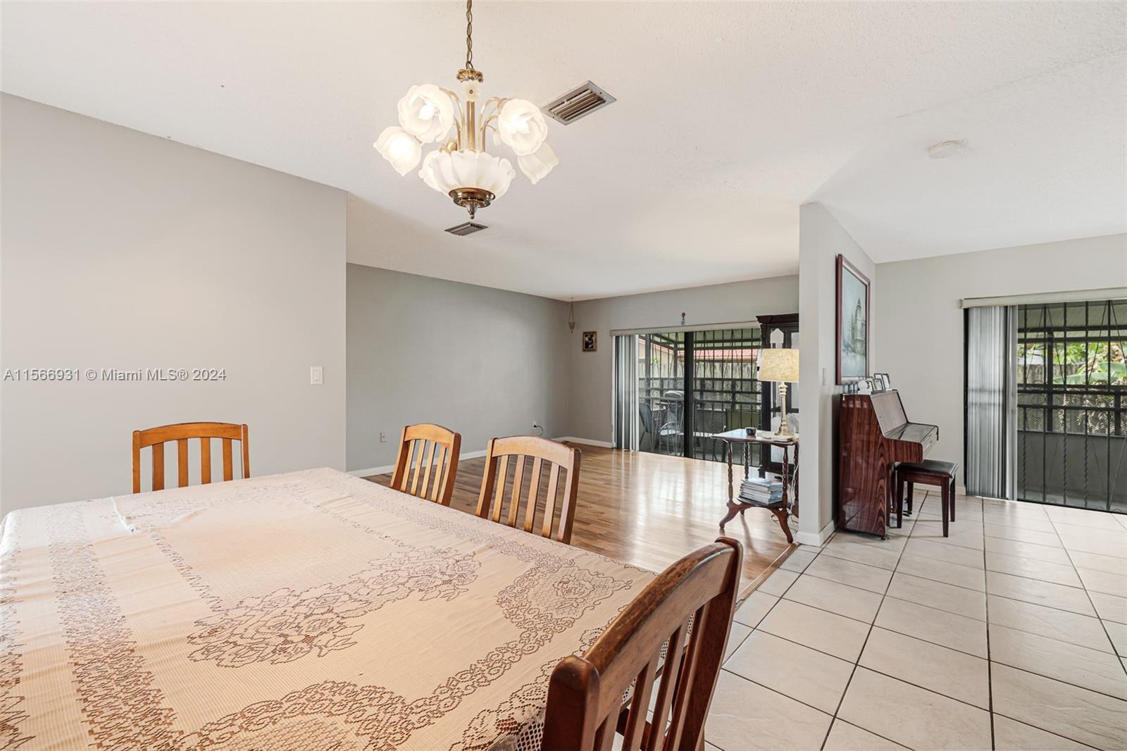 13202 Southwest 12th Lane Miami, FL 33184 - Photo 11 of 47 a bedroom with a large bed and a chandelier