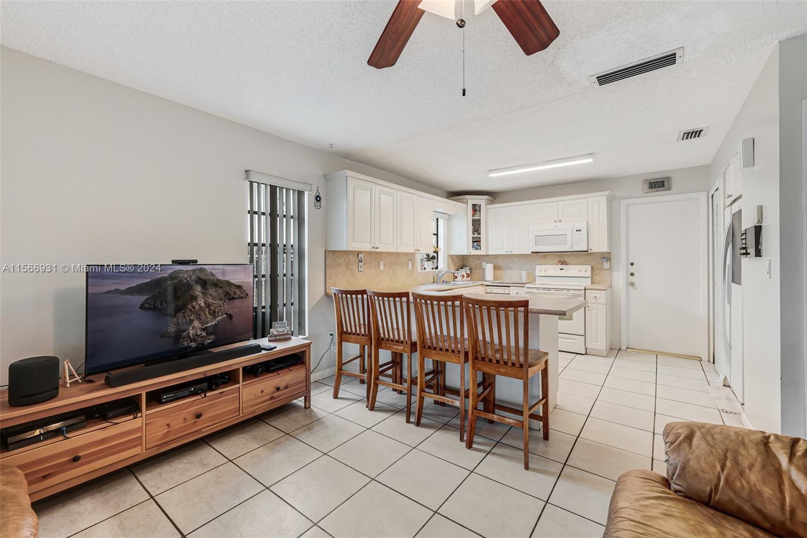 13202 Southwest 12th Lane Miami, FL 33184 - Photo 14 of 47 a living room with furniture and a flat screen tv