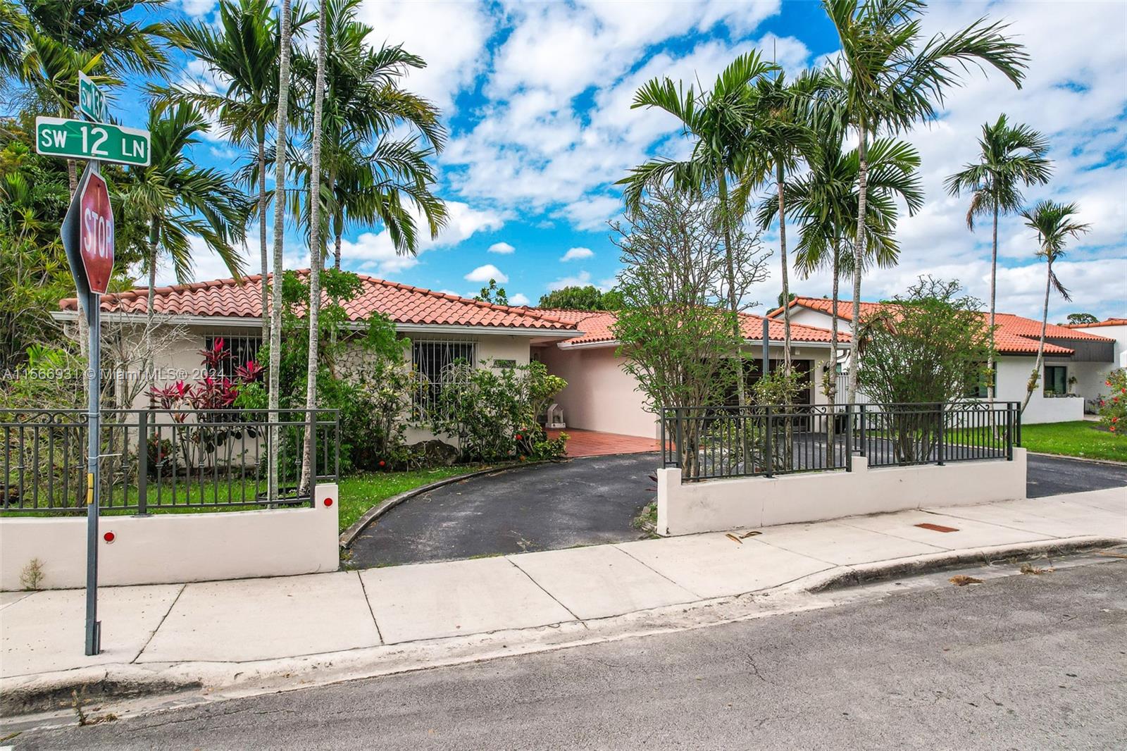 13202 Southwest 12th Lane Miami, FL 33184 - Photo 2 of 47 front view of a house with a garden