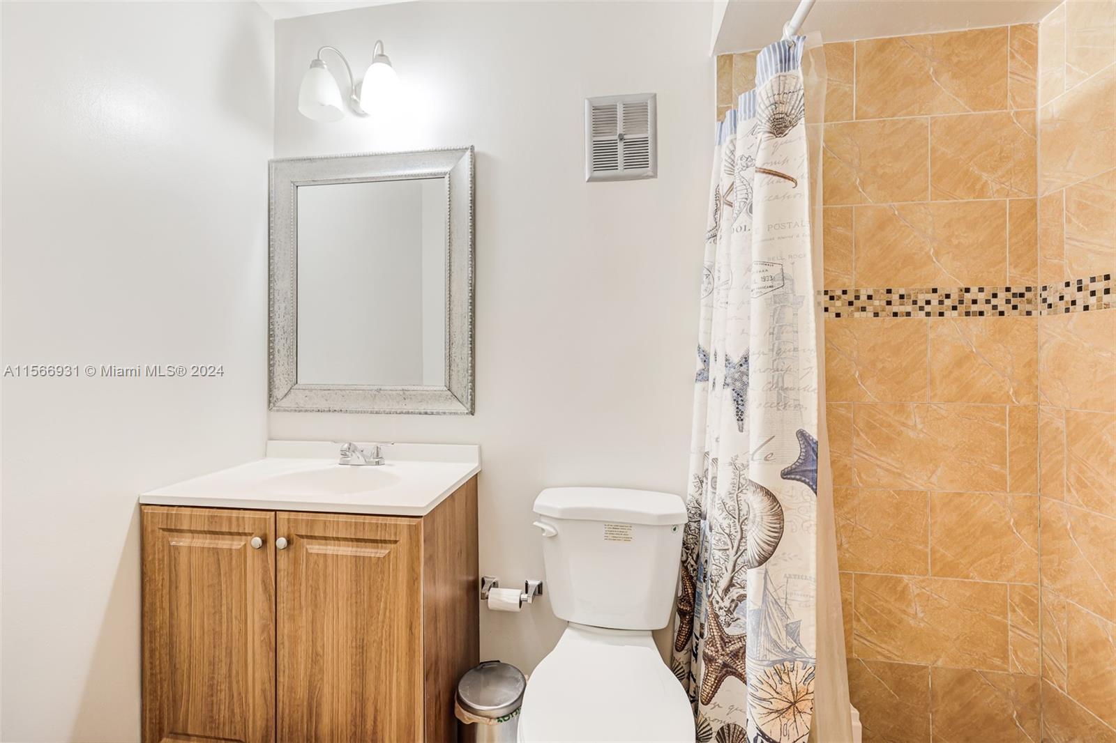 13202 Southwest 12th Lane Miami, FL 33184 - Photo 21 of 47 a bathroom with a toilet a sink and shower