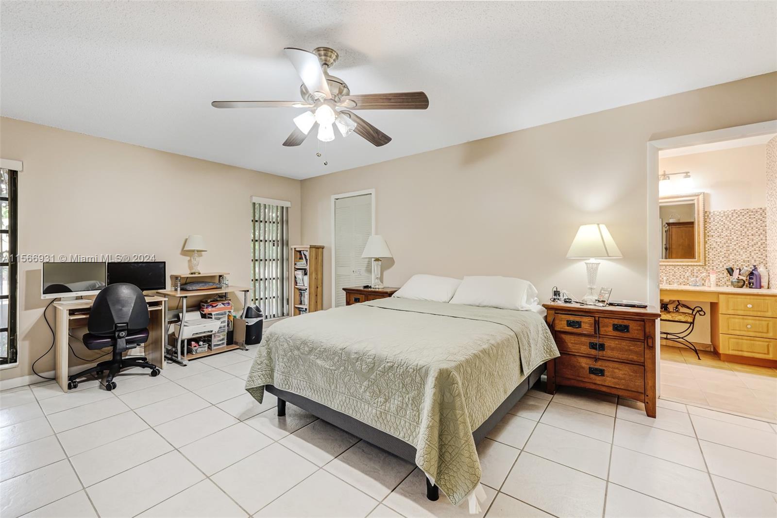13202 Southwest 12th Lane Miami, FL 33184 - Photo 23 of 47 a spacious bedroom with a bed and furniture