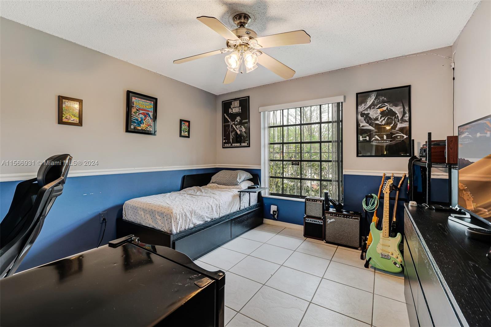 13202 Southwest 12th Lane Miami, FL 33184 - Photo 25 of 47 a bedroom with a bed and wooden floor