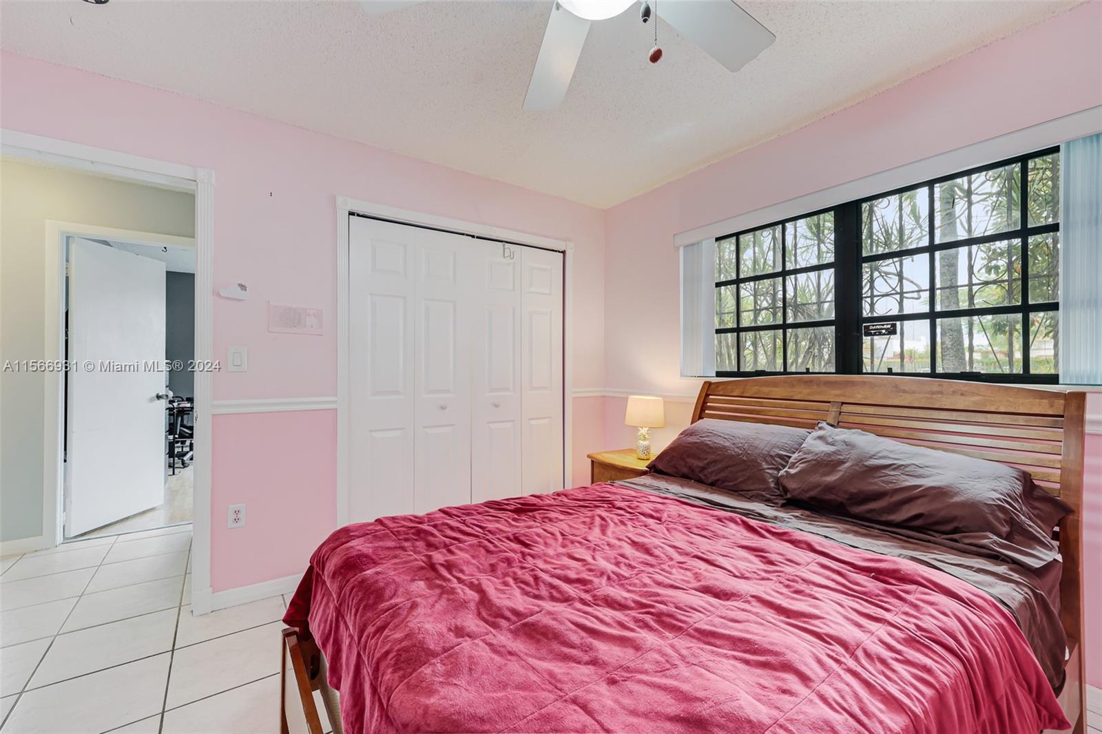 13202 Southwest 12th Lane Miami, FL 33184 - Photo 28 of 47 a bedroom with a large bed and a window