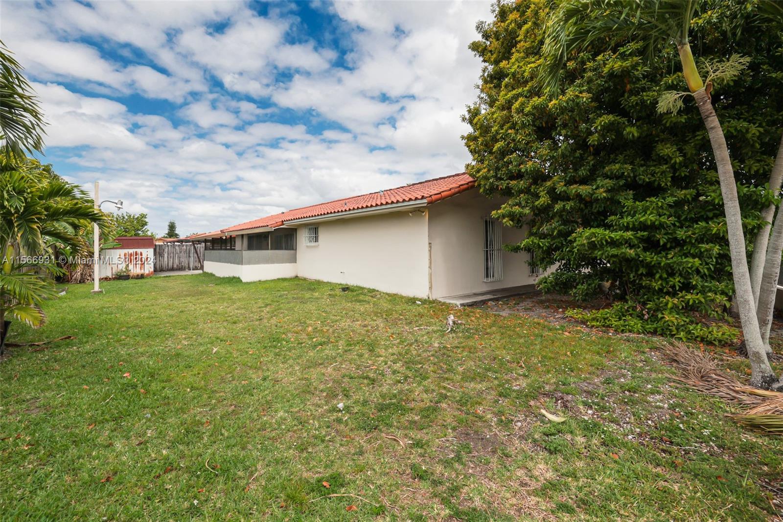 13202 Southwest 12th Lane Miami, FL 33184 - Photo 38 of 47 a backyard of a house with plants and large tree