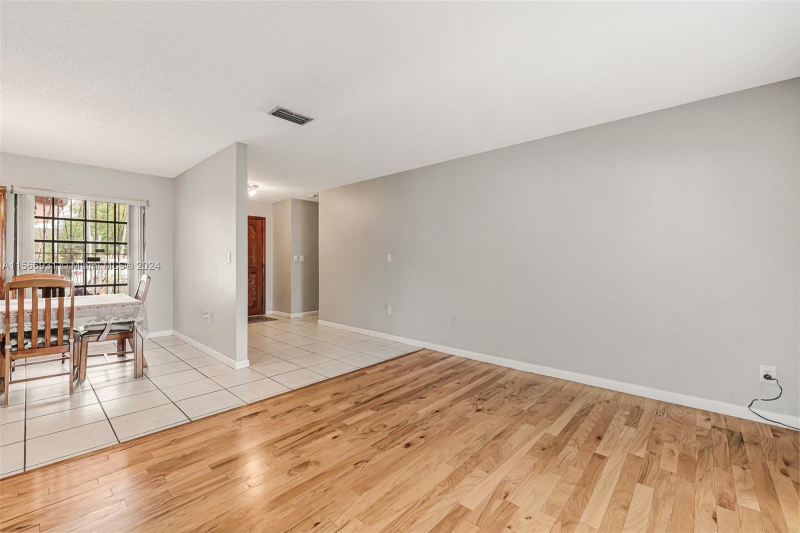 13202 Southwest 12th Lane Miami, FL 33184 - Photo 8 of 47 a view of empty room with wooden floor and fan