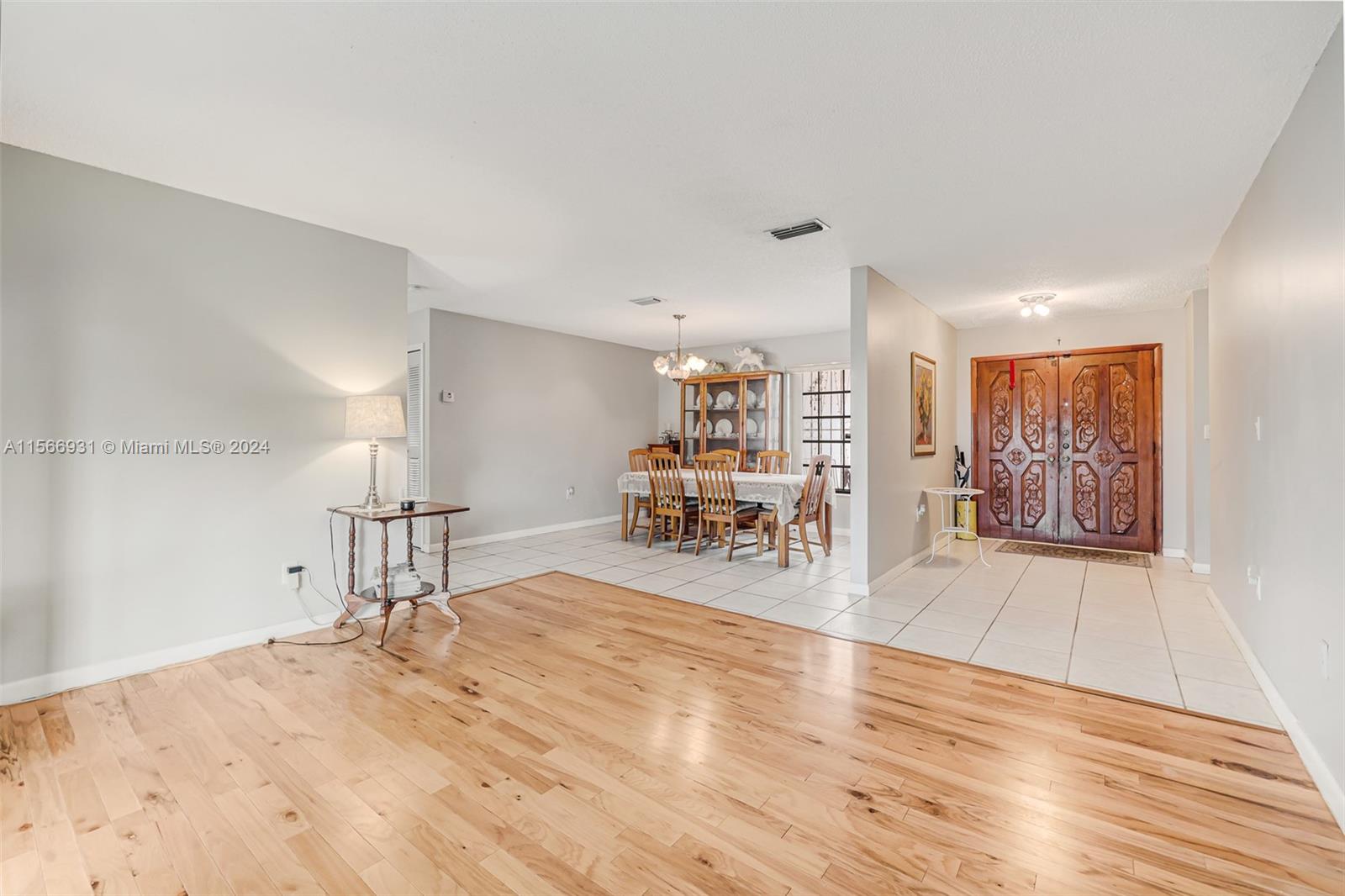 13202 Southwest 12th Lane Miami, FL 33184 - Photo 9 of 47 a view of a livingroom with a dinning table and chair