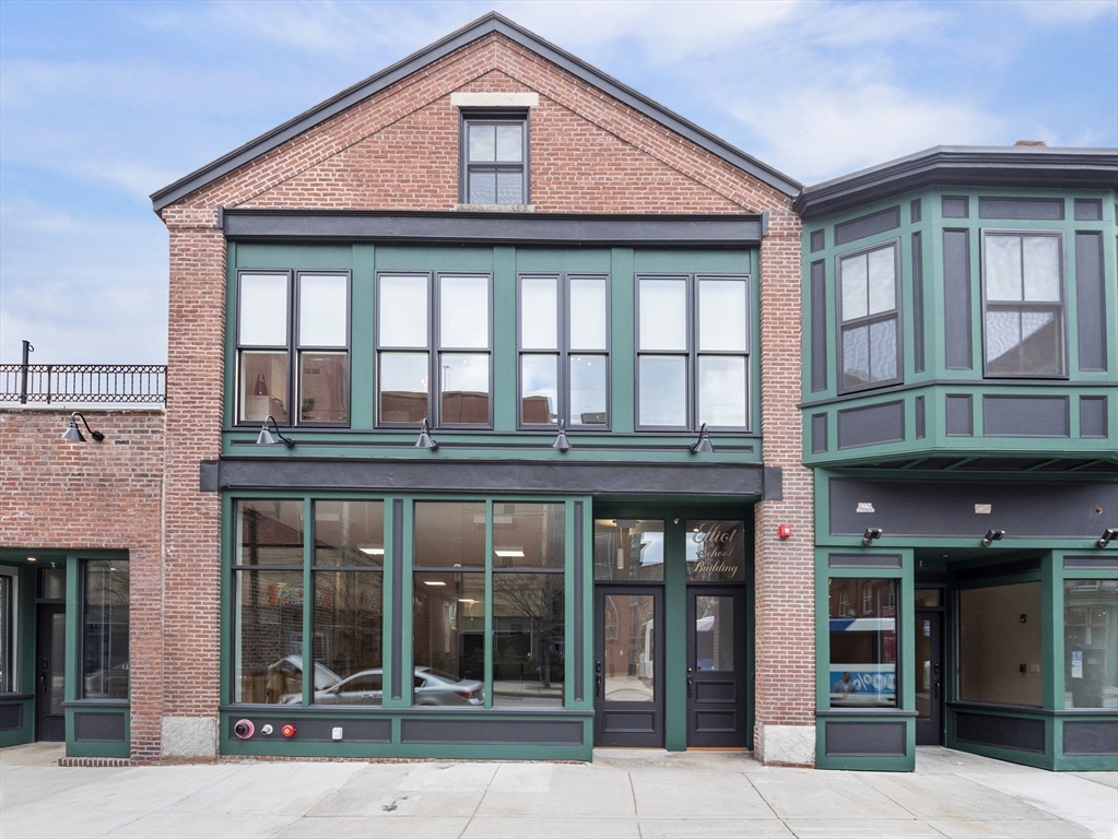 140 Middlesex Street, Unit 3 Lowell, MA 01852 - Photo 29 of 30 front view of a brick building with a lots of windows